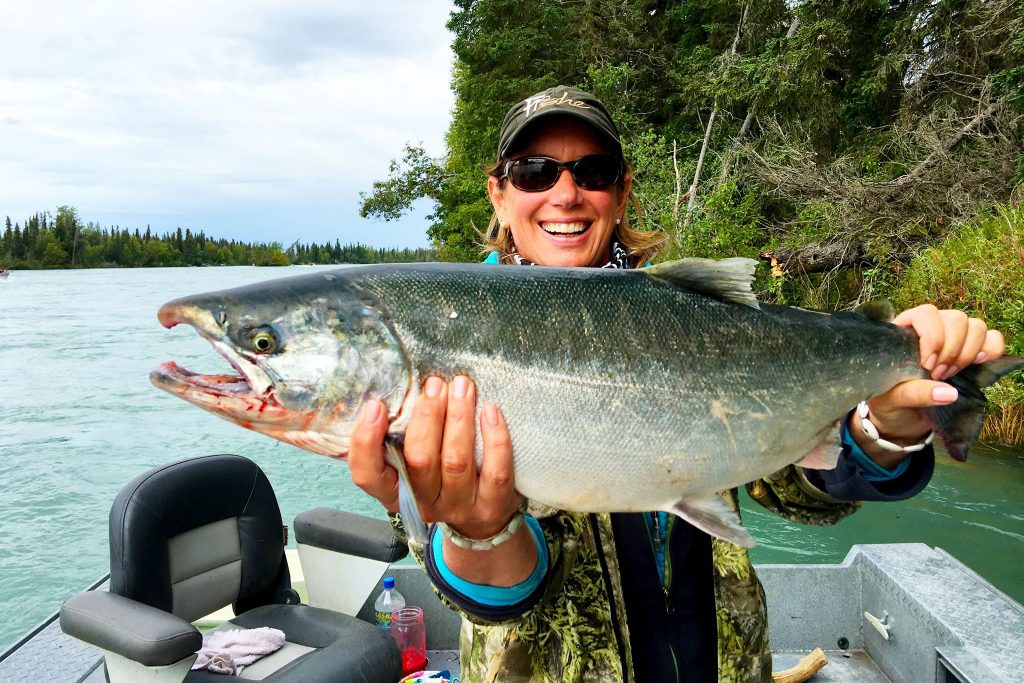 woman holding silver salmon in Kenai