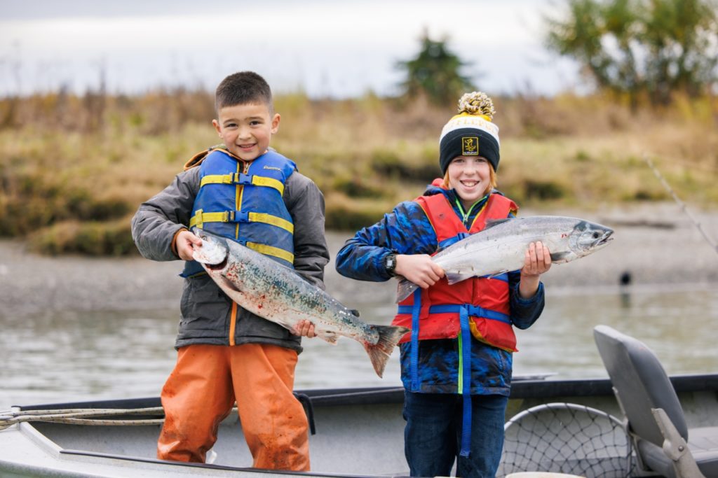 Kids holding salmon on the Kenai River