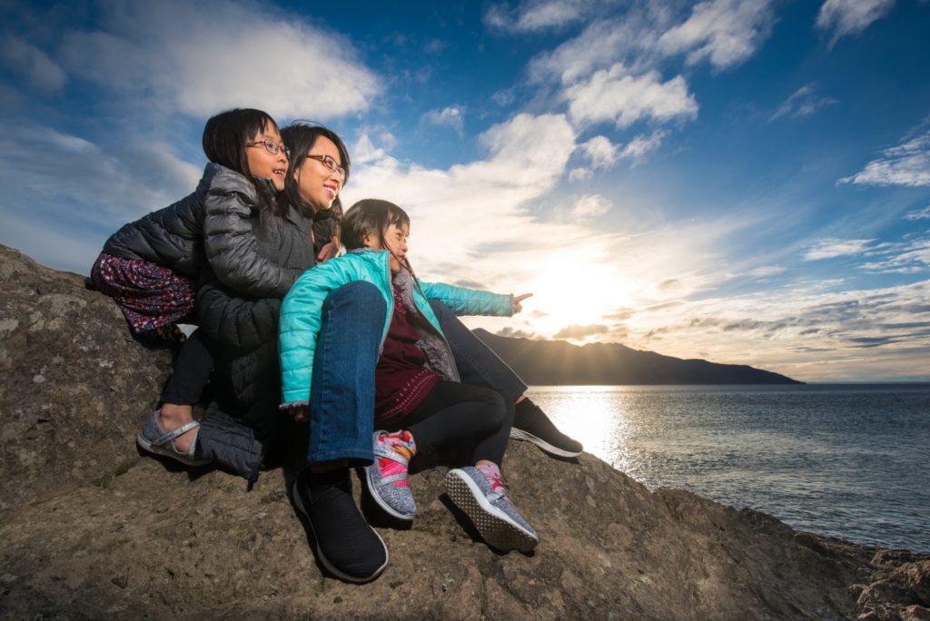 Mother and daughters enjoying Alaskan sunset